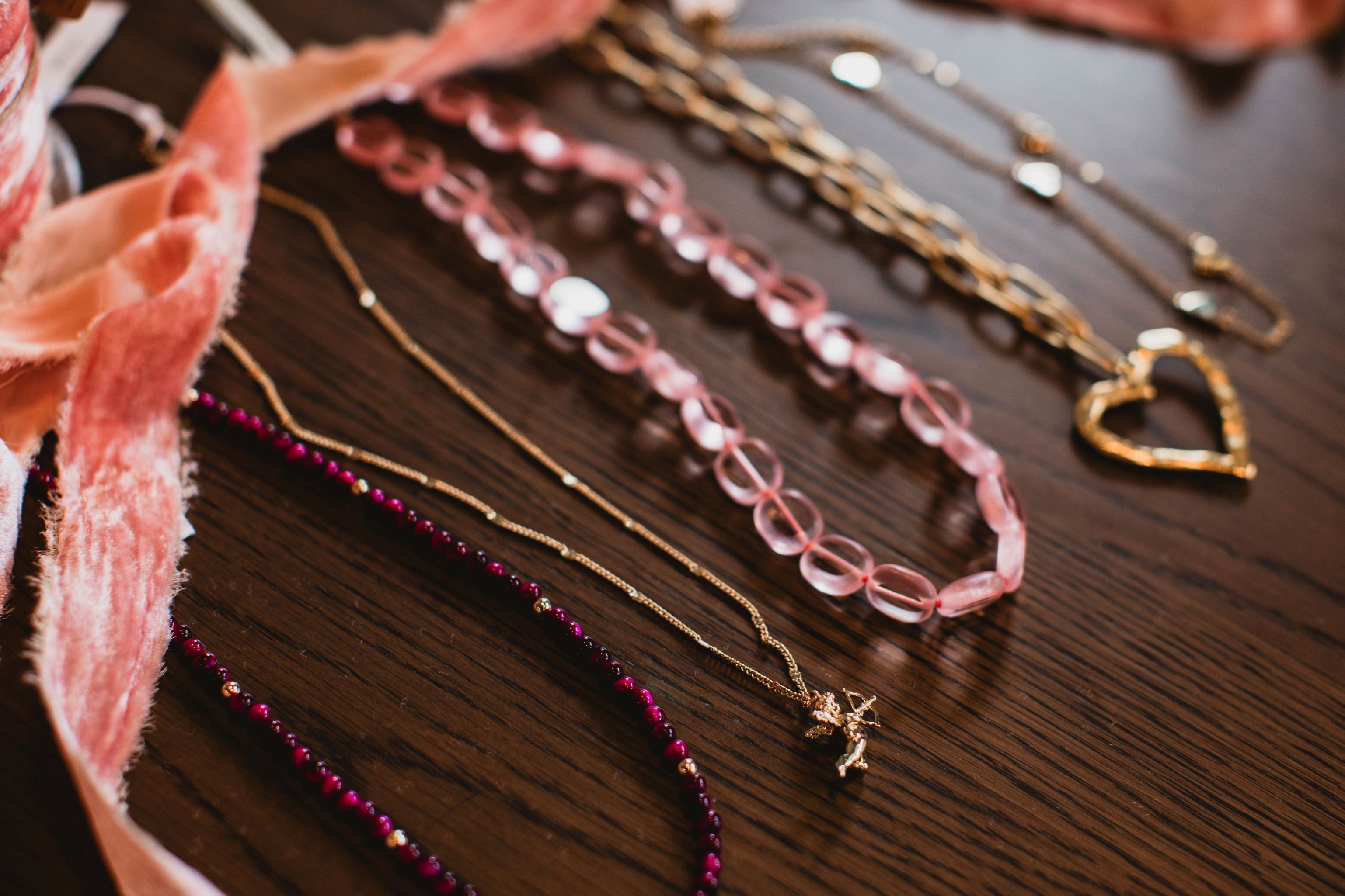 Photo of several pink and gold necklaces