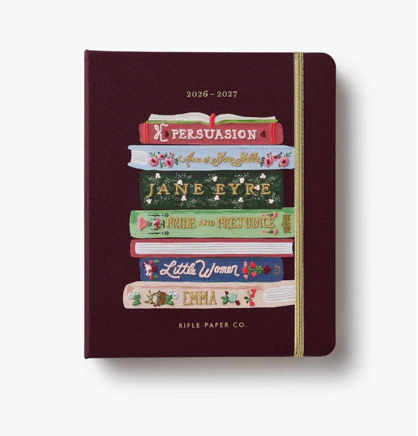 Maroon planner with book design and 'Rifle Paper Co.' branding on a white background